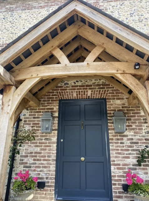 Oak frame porch with blue front door
